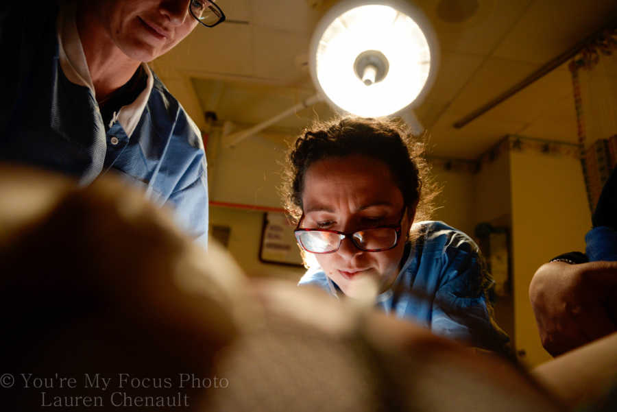 Close up of doctor's faces who are delivering baby