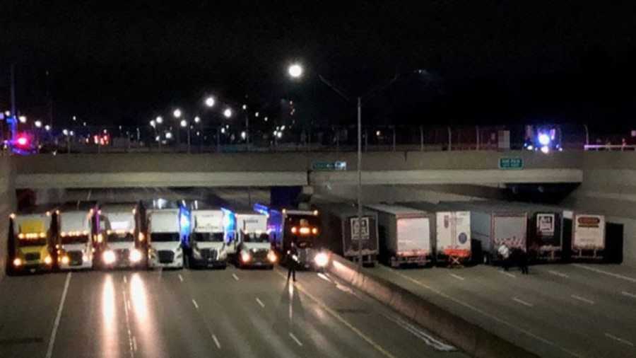 13 semi trucks lining Michigan freeway under bridge to stop man from jumping off of it