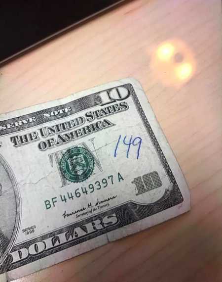 $10 bill that someone wrote 149 on which is woman's late husband's badge number