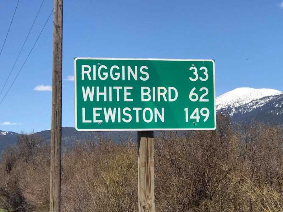 Sign saying, "Lewiston 149 miles" which is where wife was going and her late husbands badge number was 149