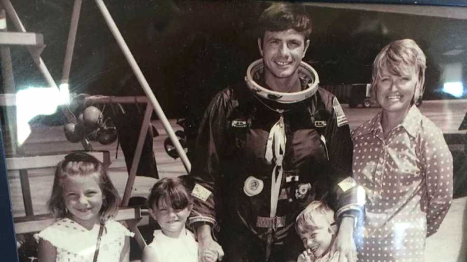 Vintage photo of dad in spacesuit next to wife and three kids