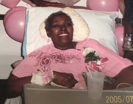 Woman who is dying of cancer smiling in hospital bed