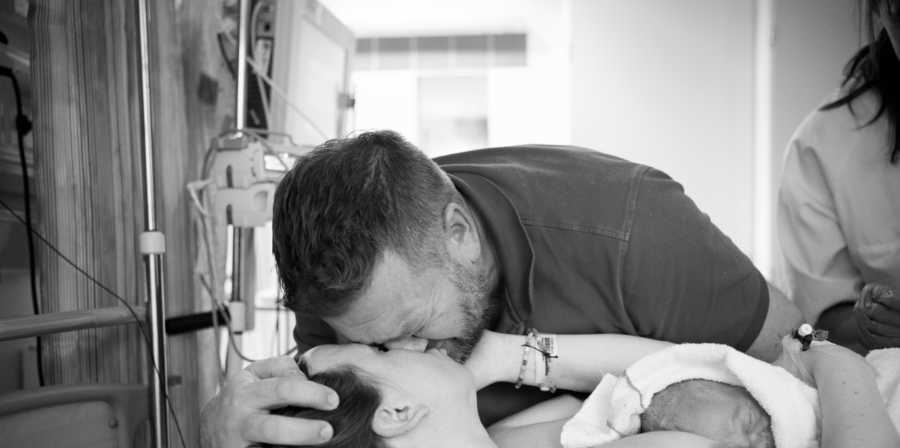 Husband kisses wife who just gave birth 