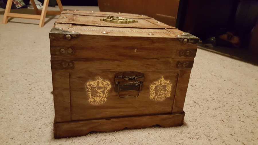 Ravenclaw and Slytherin crests on side of trunk