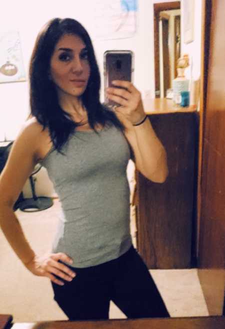 Woman smiles in mirror selfie after dealing with PTSD