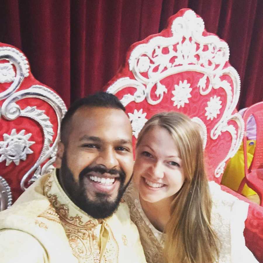 Husband and wife who will adopt a child from India, smile in selfie wearing tradition Indian clothing 