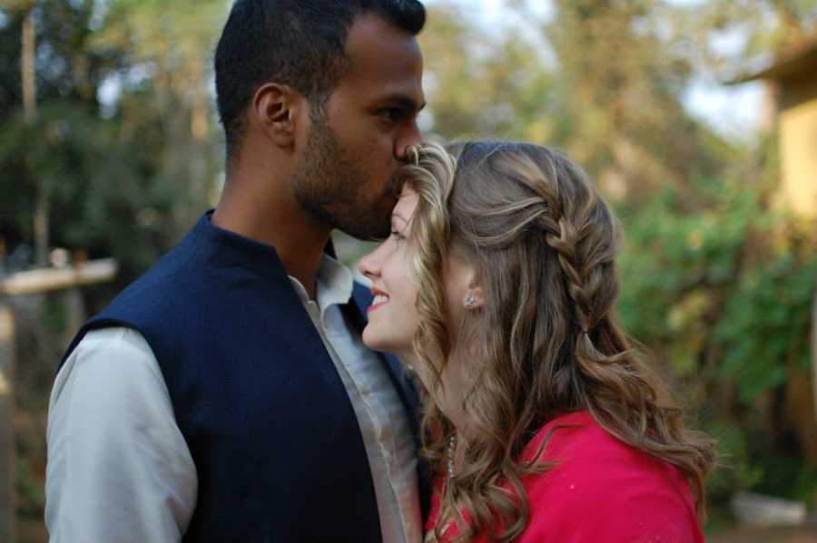 Man kissing his fiancee on the forehead