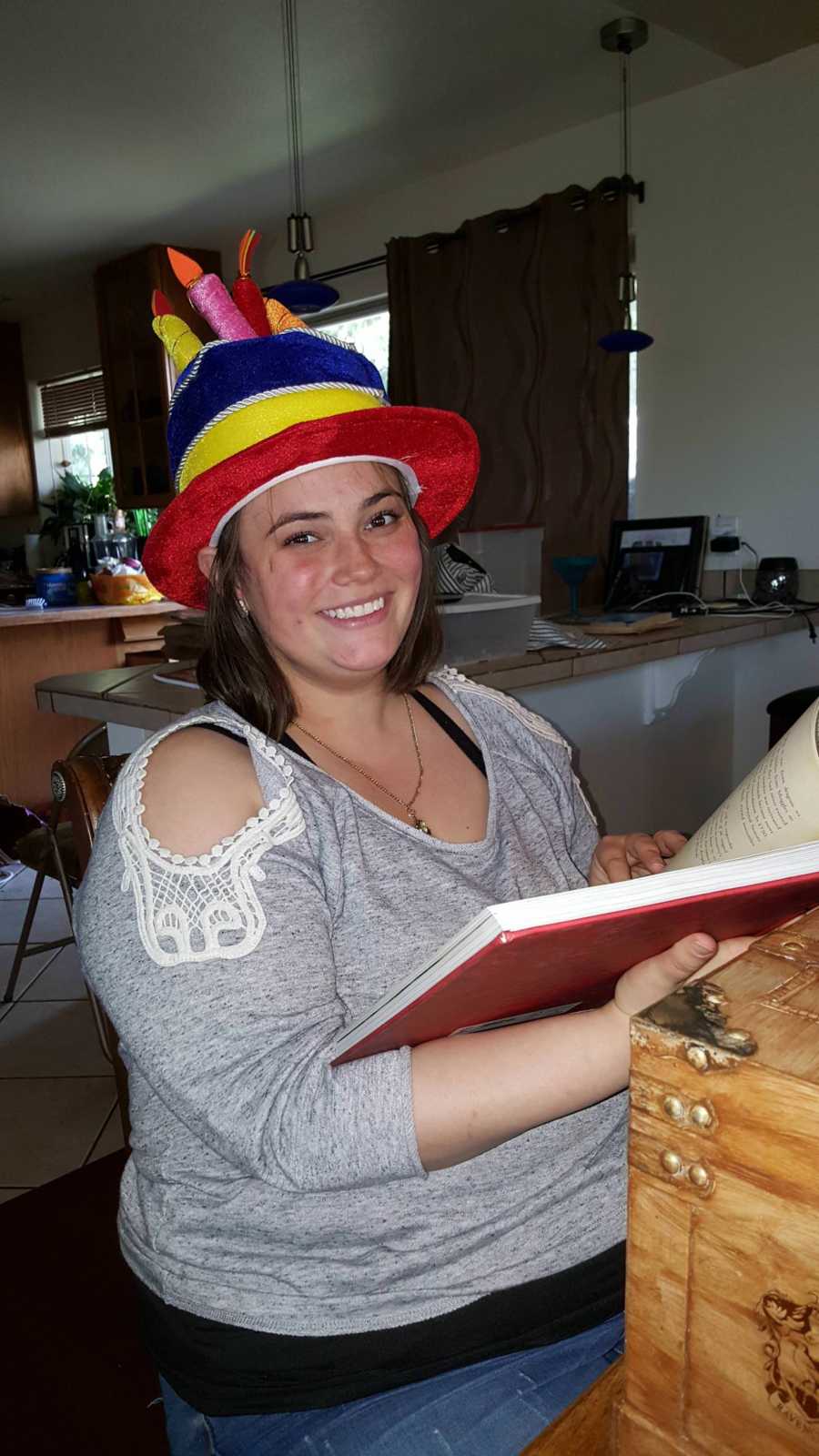 Girlfriend smiling while reading Harry Potter book