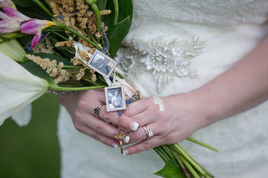 Bride holds bouquet of flowers that has little pictures of her late son on it who donated his heart