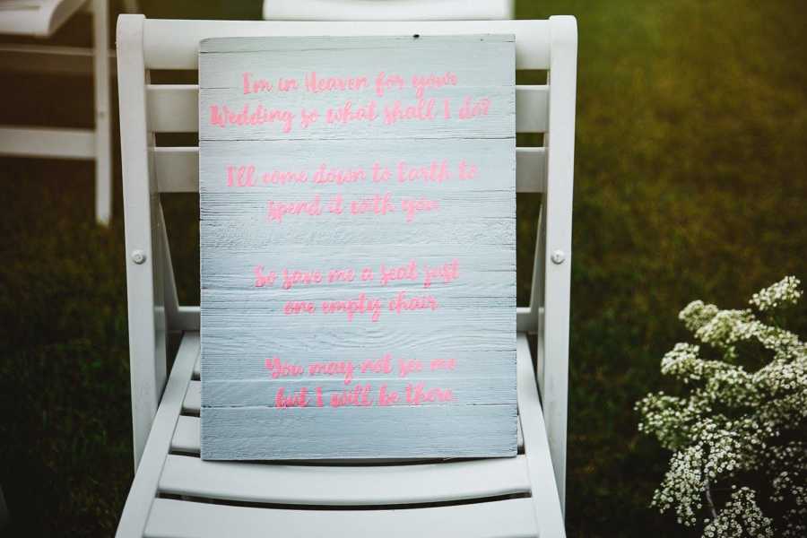 Sign placed on chair for bride's late son at her wedding