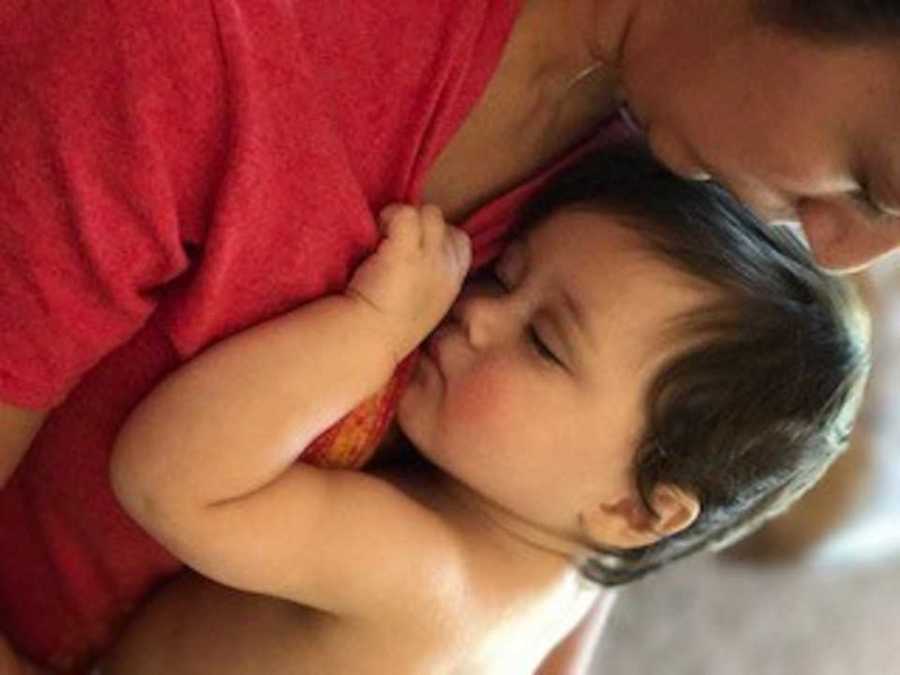 Close up of toddler who has since passed away sleeping on mothers chest