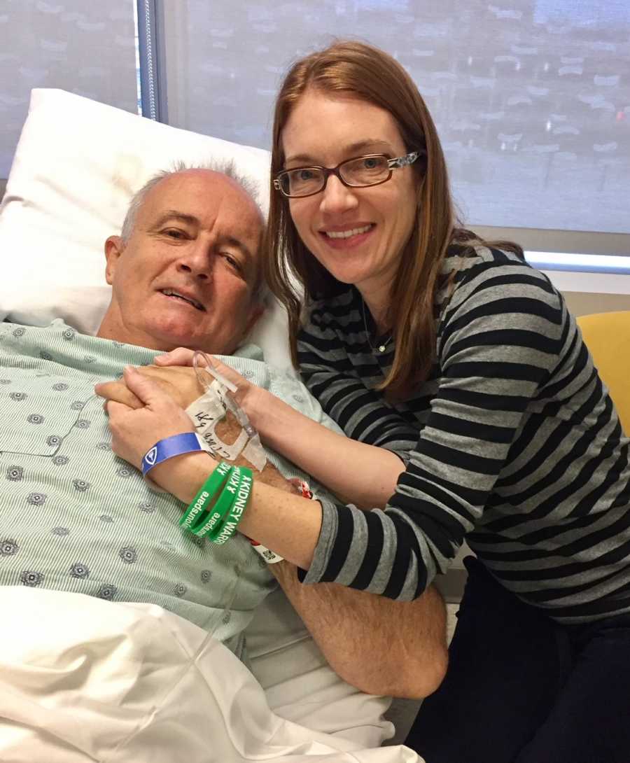 Wife holds husband who needs new kidney's hands while he lies in hospital bed 