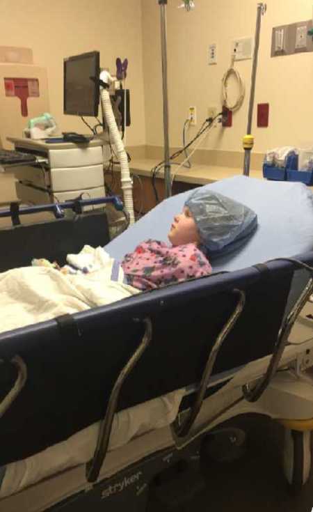 Three year old in hospital bed at burn center to be cleaned after receiving burns from treadmill