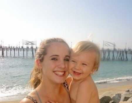 20 year old mother and son smile at beach