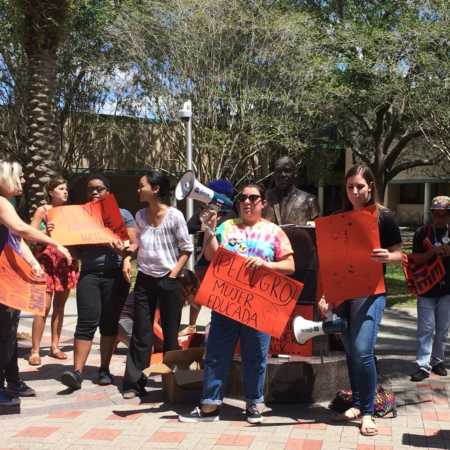 Young woman leading campus wide protest educating people on policies and realities of undocumented community