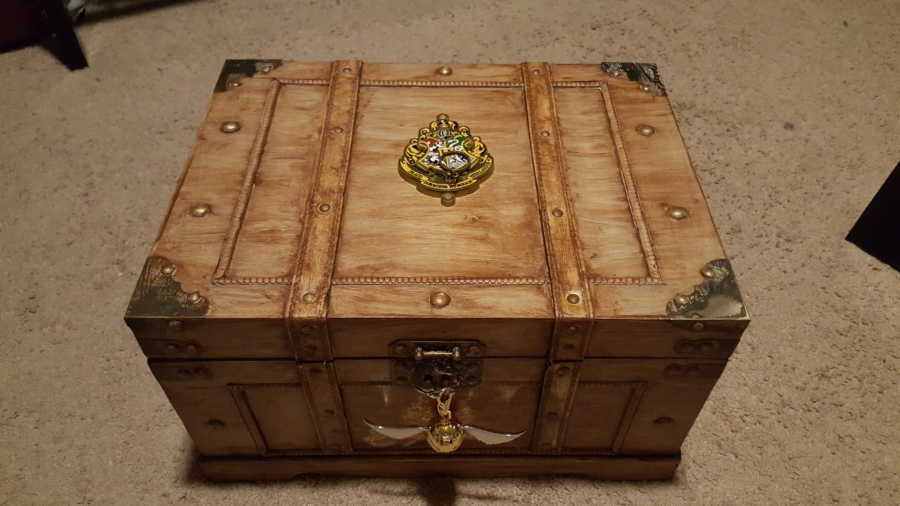 Trunk with Hogwarts crest and charm of golden snitch on the lock
