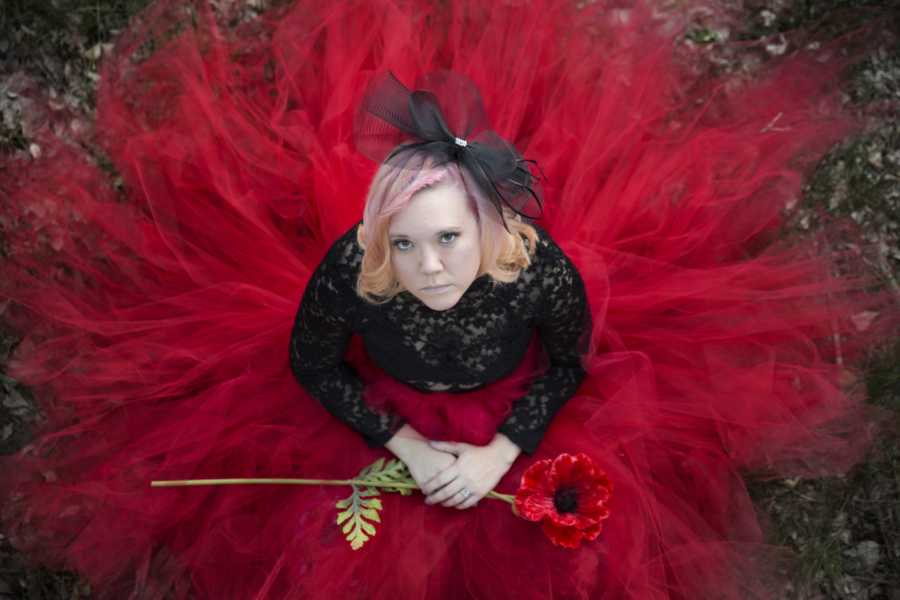 Aeriel view of woman with Diminished Ovarian Reserve in red tool skirt holding red flower