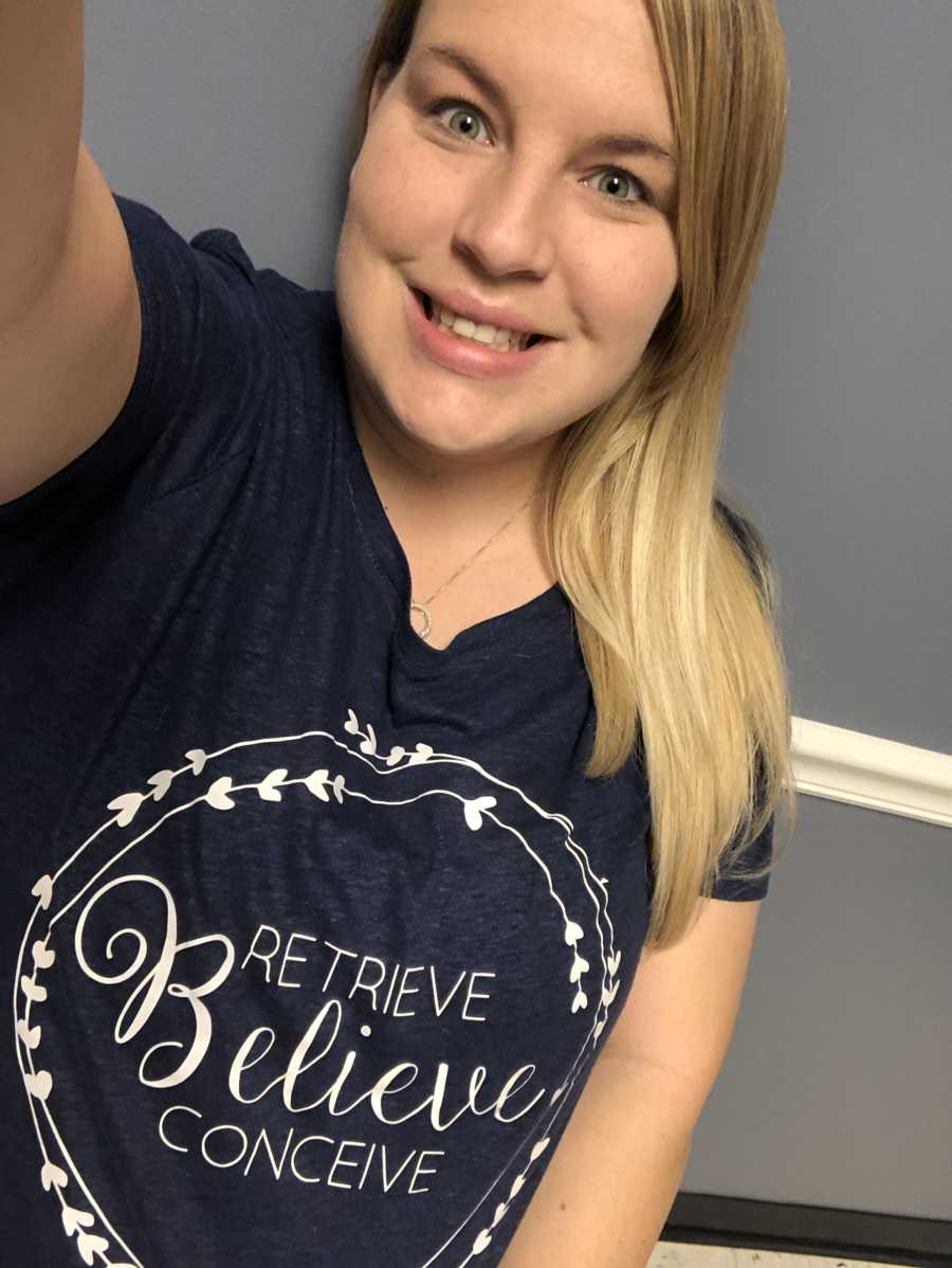 Woman with fertility issues wearing shirt saying, "retrieve, believe, conceive" in selfie