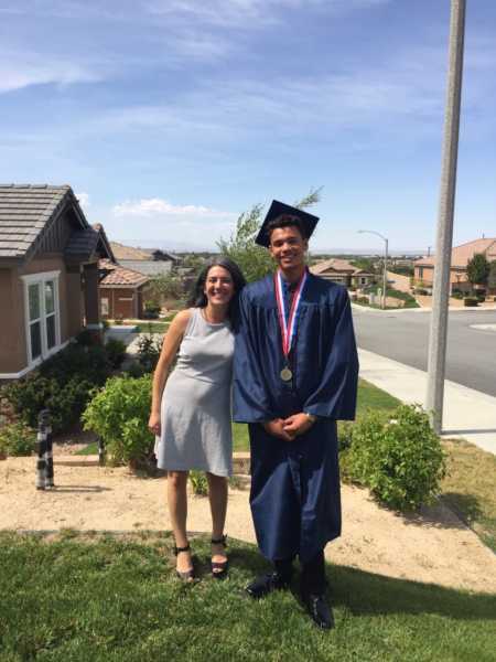 Teen stands with foster mom on day of high school graduation