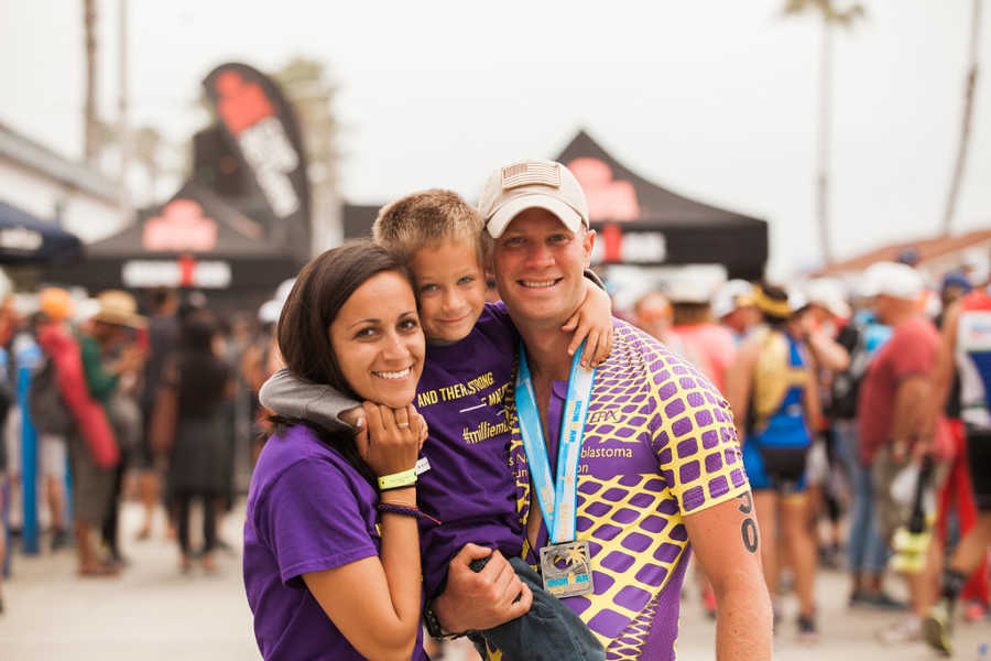 Mother and father hold son wearing tshirts for Neuroblastoma Cancer which is what they lost their daughter to