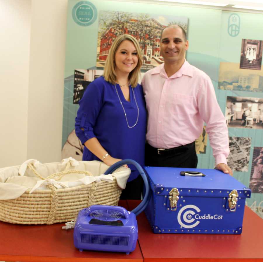 Mother and father of still born baby stand over CuddleCot that they wanted to bring to every hospital