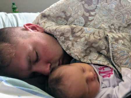 Soldier father asleep with infant baby 
