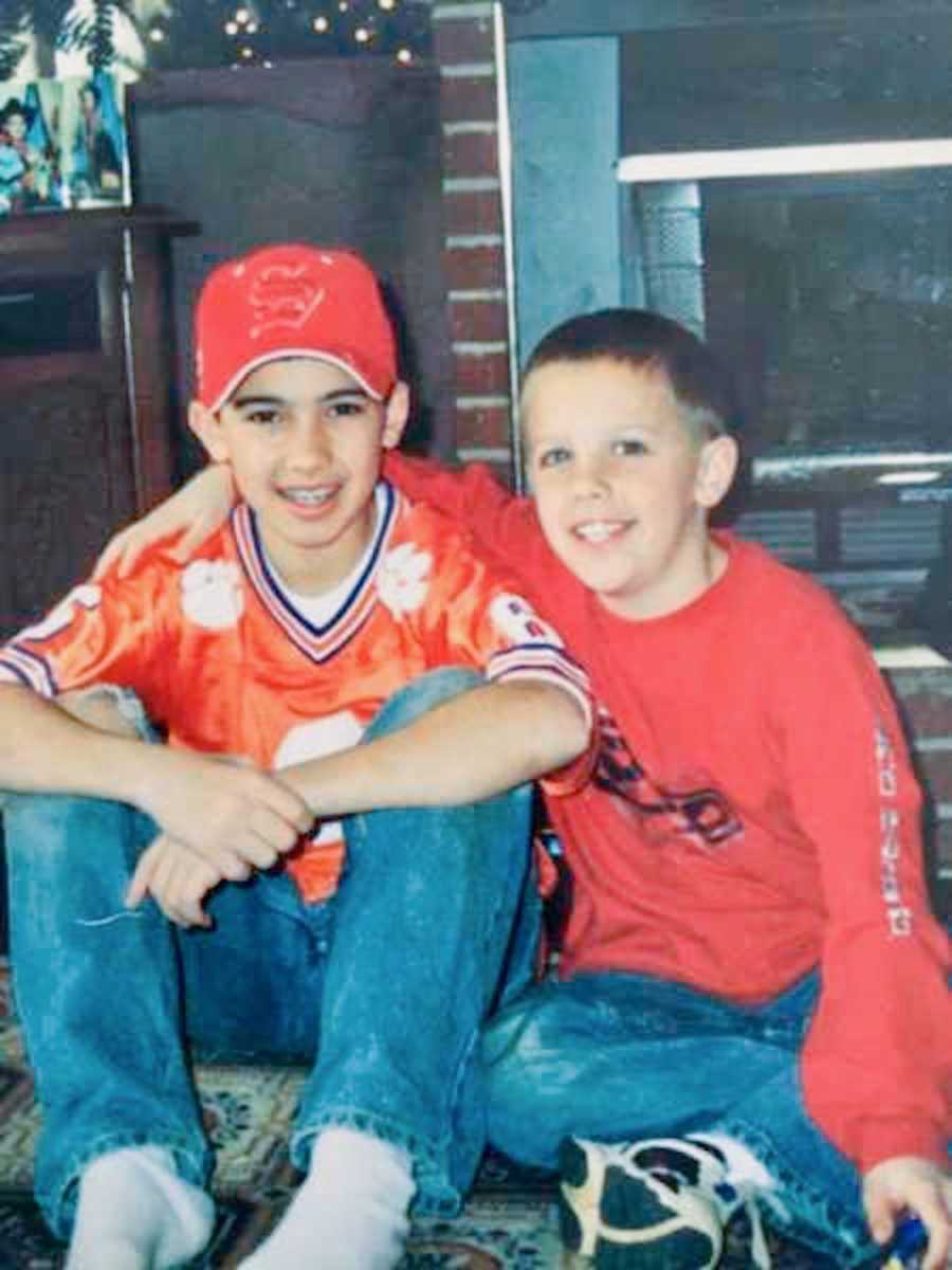 Older brother sits on ground with younger brother who died of drug abuse 