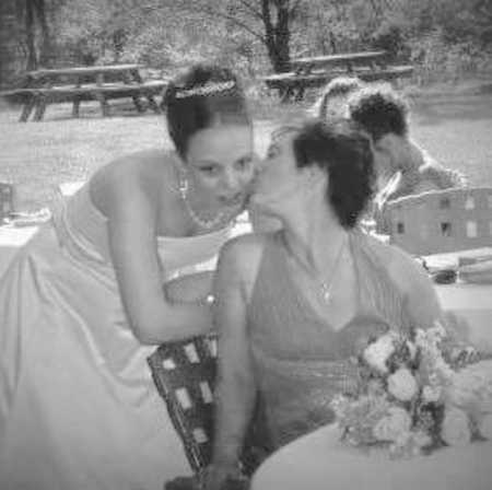 Woman on her wedding day whose mother who died in Sandy Hook shooting kisses her on cheeck