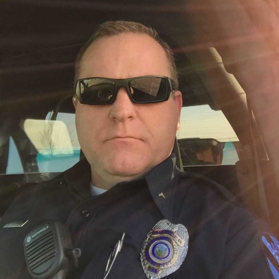 Woman's cop husband in uniform with straight face in selfie who has since passed away