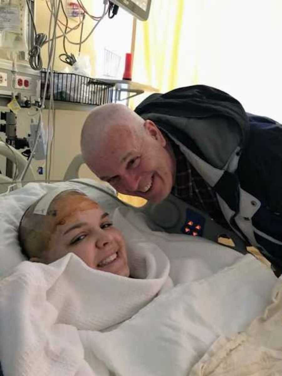 21-year-old girl and dad smile with shaved heads
