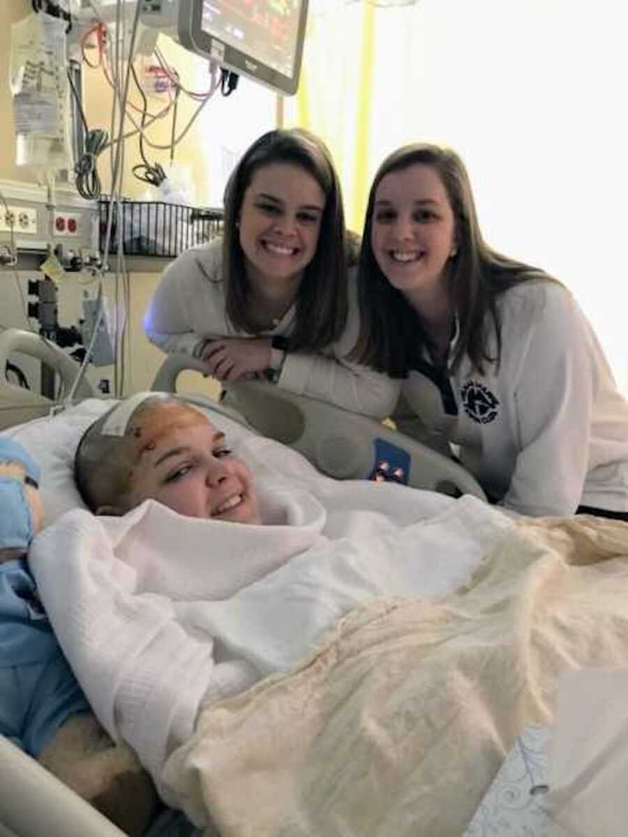 girl smiles with sisters after surgery