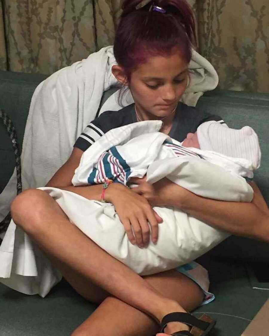 girl holds newborn sibling