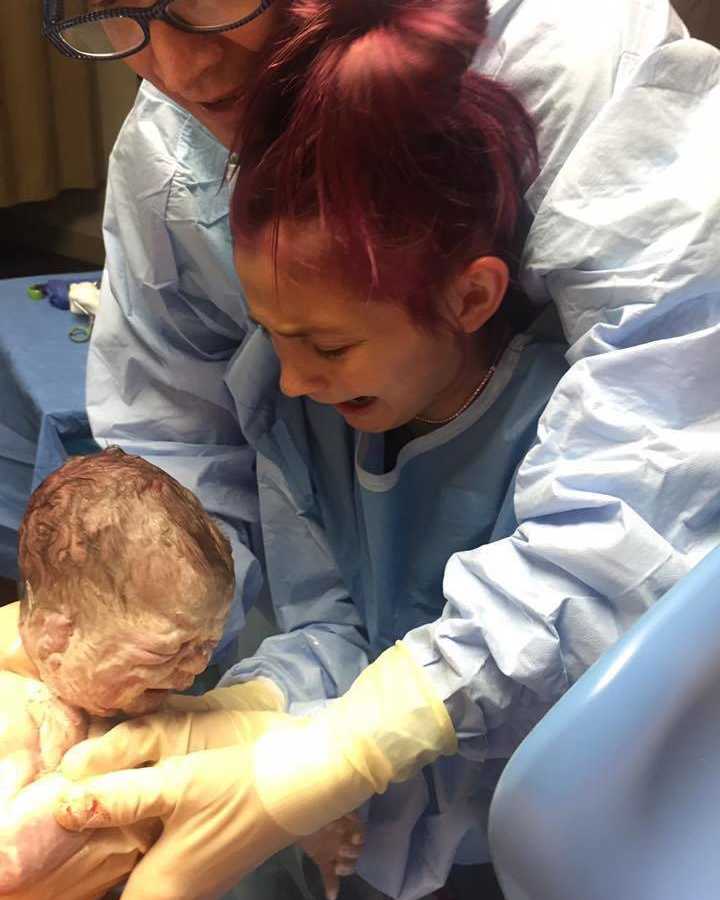 12 year old crying at the sight of newborn sibling being delivered in arms of father