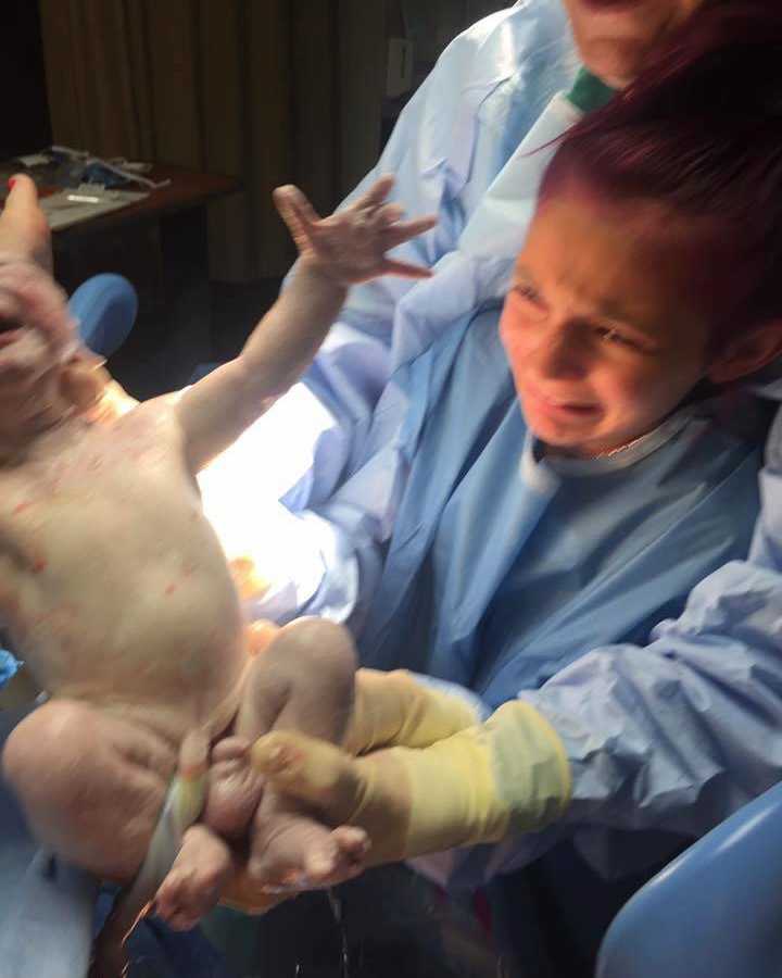 12 year old crying at sight of newborn sibling with umbilical chord attached