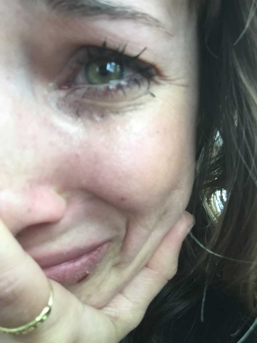 Woman who struggles with PTSD with tears in her eyes and mascara running in selfie