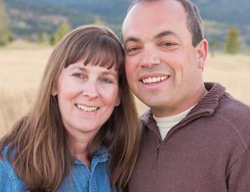 Married couple smile for a photo during a family photoshoot