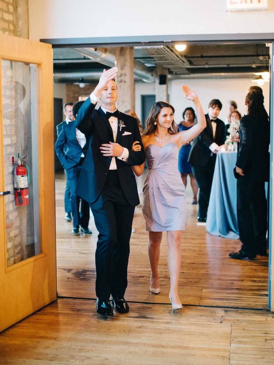Maid of honor and bride of sister enters wedding reception with groomsman 