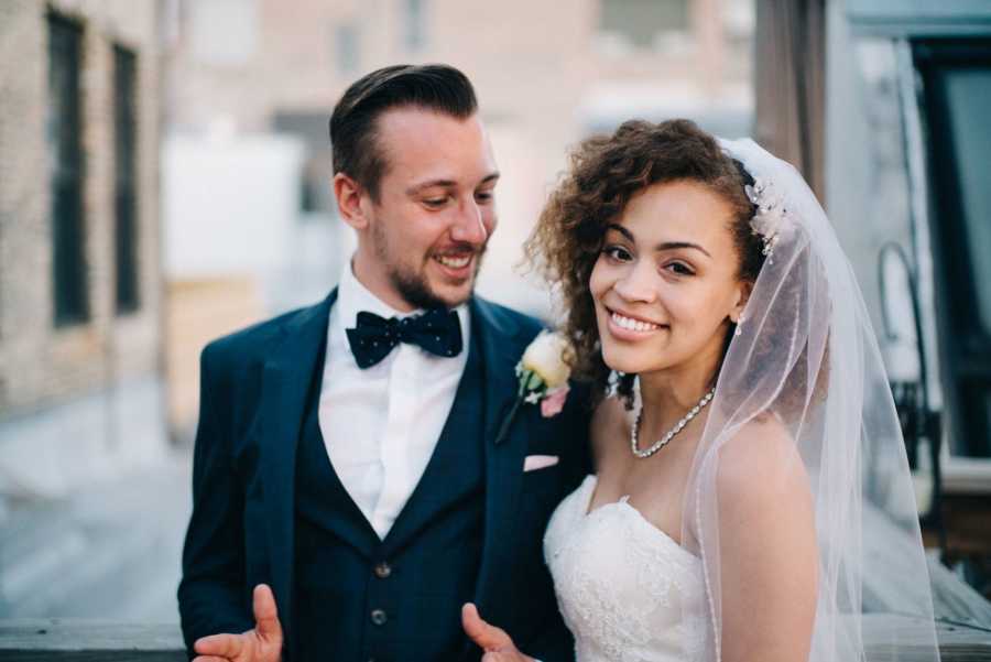 Newlyweds take candid photo during wedding photoshoot