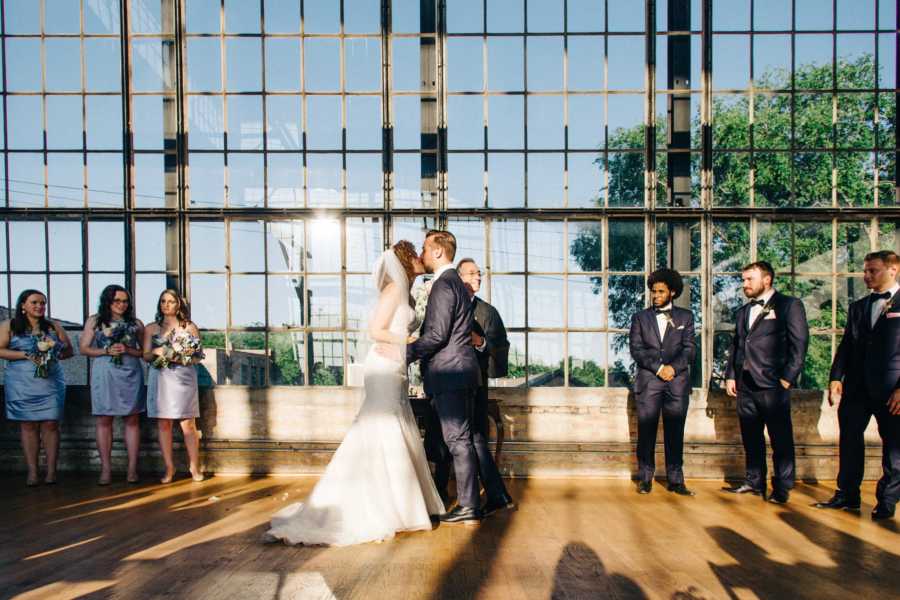 Couple redo their "I do" kiss after bride's sister fainted behind them