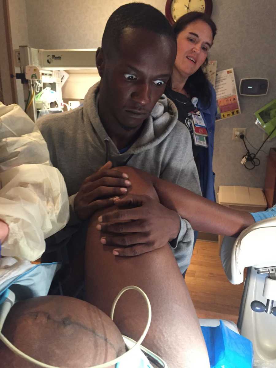 Father looks terrified while watching his wife give birth
