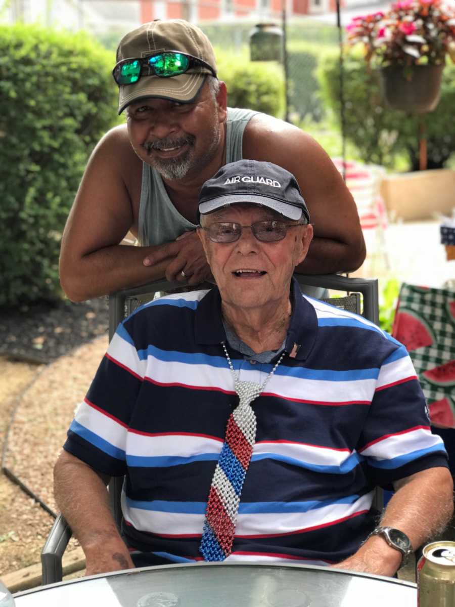 Father and son take a photo together while outside on a gazebo