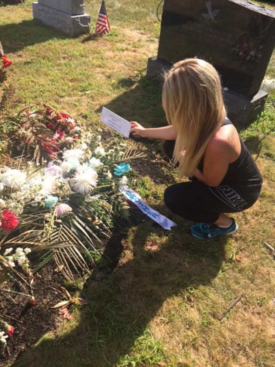 Sister mourns the loss of her brother while visiting his gravesite