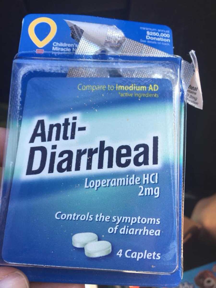 Man having stomach problems takes a photo of anti-diarrheal medicine