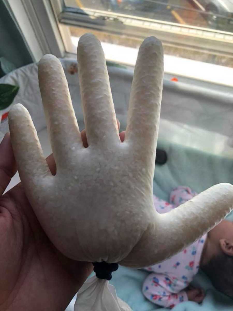 Woman takes a photo of a glove filled with rice