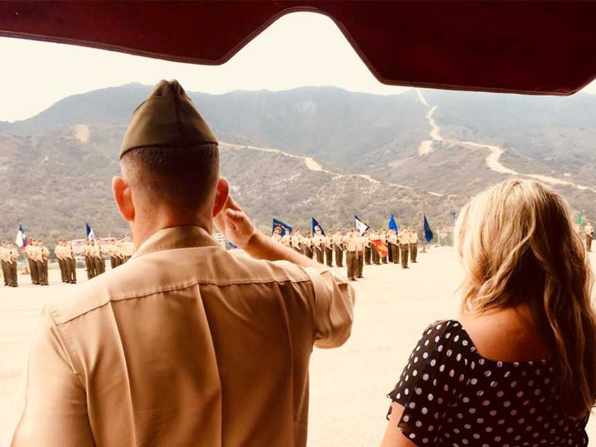 Military wife stands next to her husband in uniform