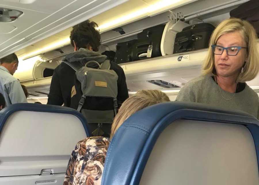 Man snaps candid photo of woman comforting distraught woman on a flight
