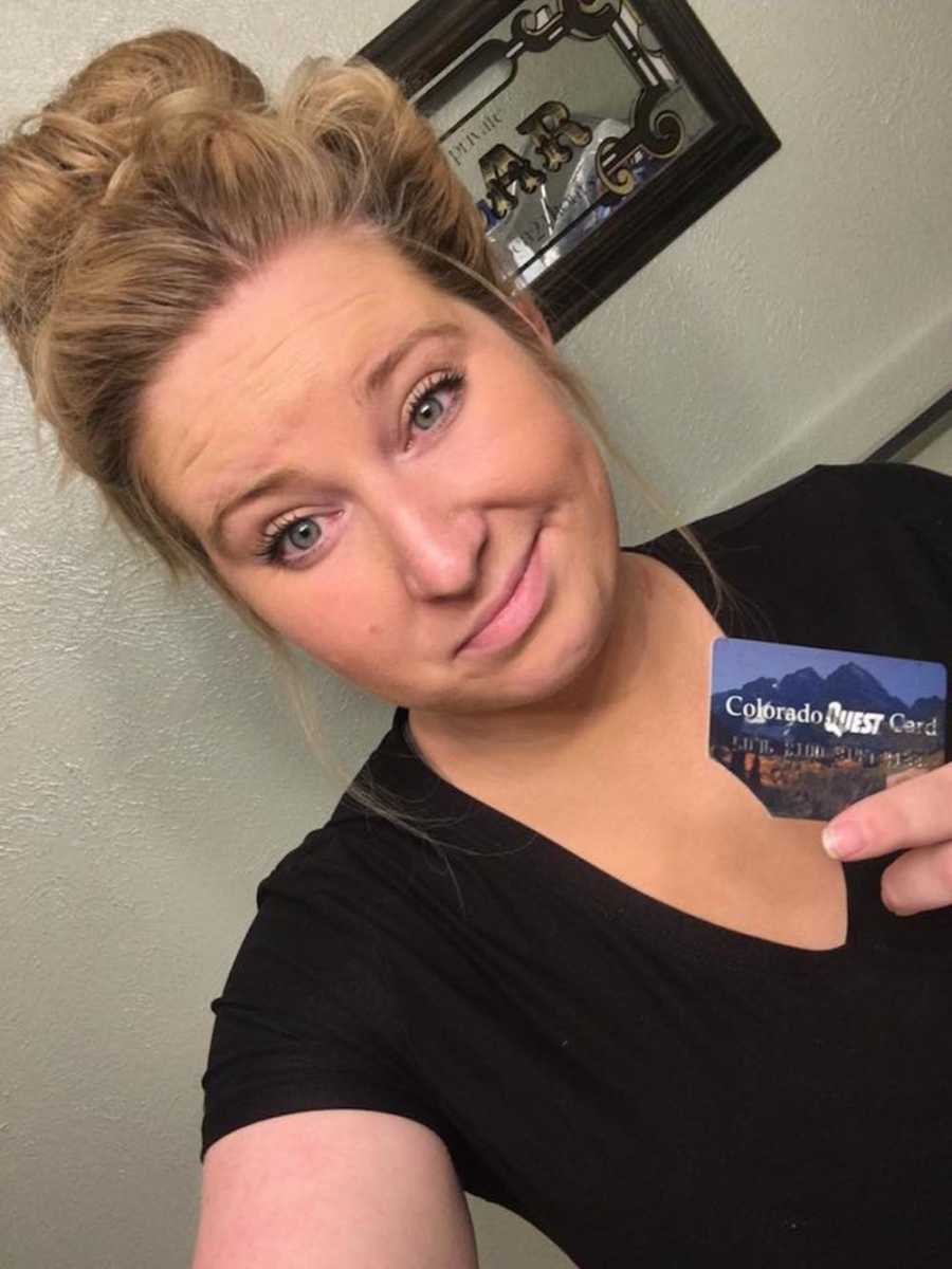 Mom takes a selfie with old food card to "remember where she came from"