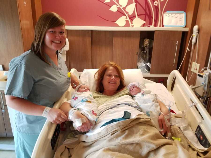 Mom and grandma smile with the newborn twins conceived through surrogacy