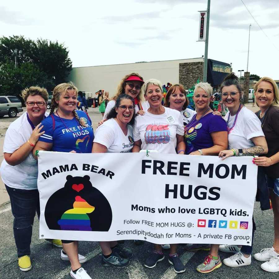 Group of women give out "free mom hugs" at pride parade