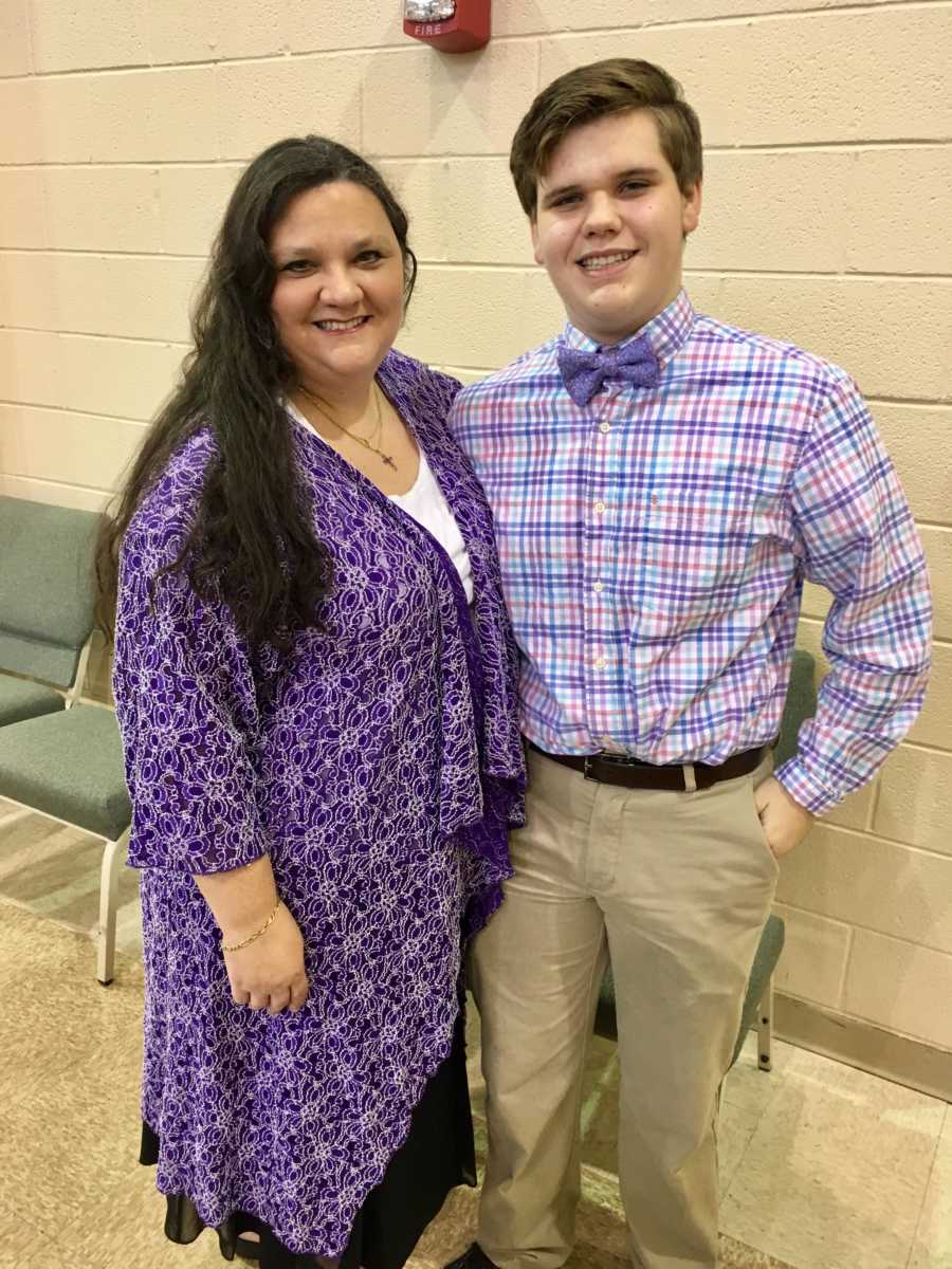 Mom and son take photo together while in matching purple outfits in church